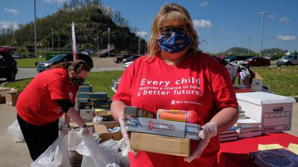 Image of volunteers packing care kits for Save The Children.